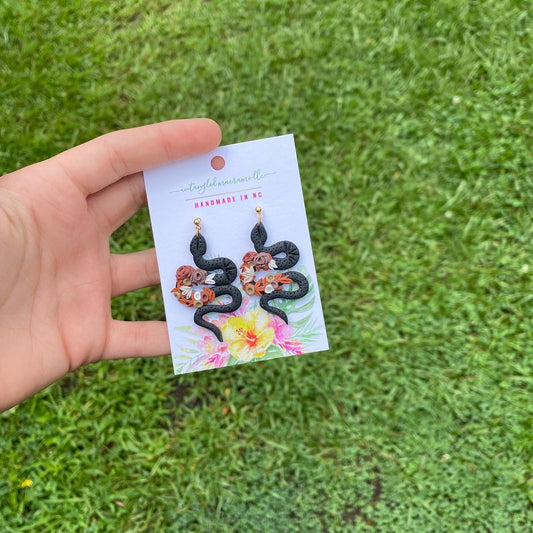 Black floral snake earrings